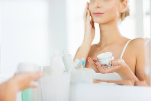 Woman applying face cream during her daily skincare routine